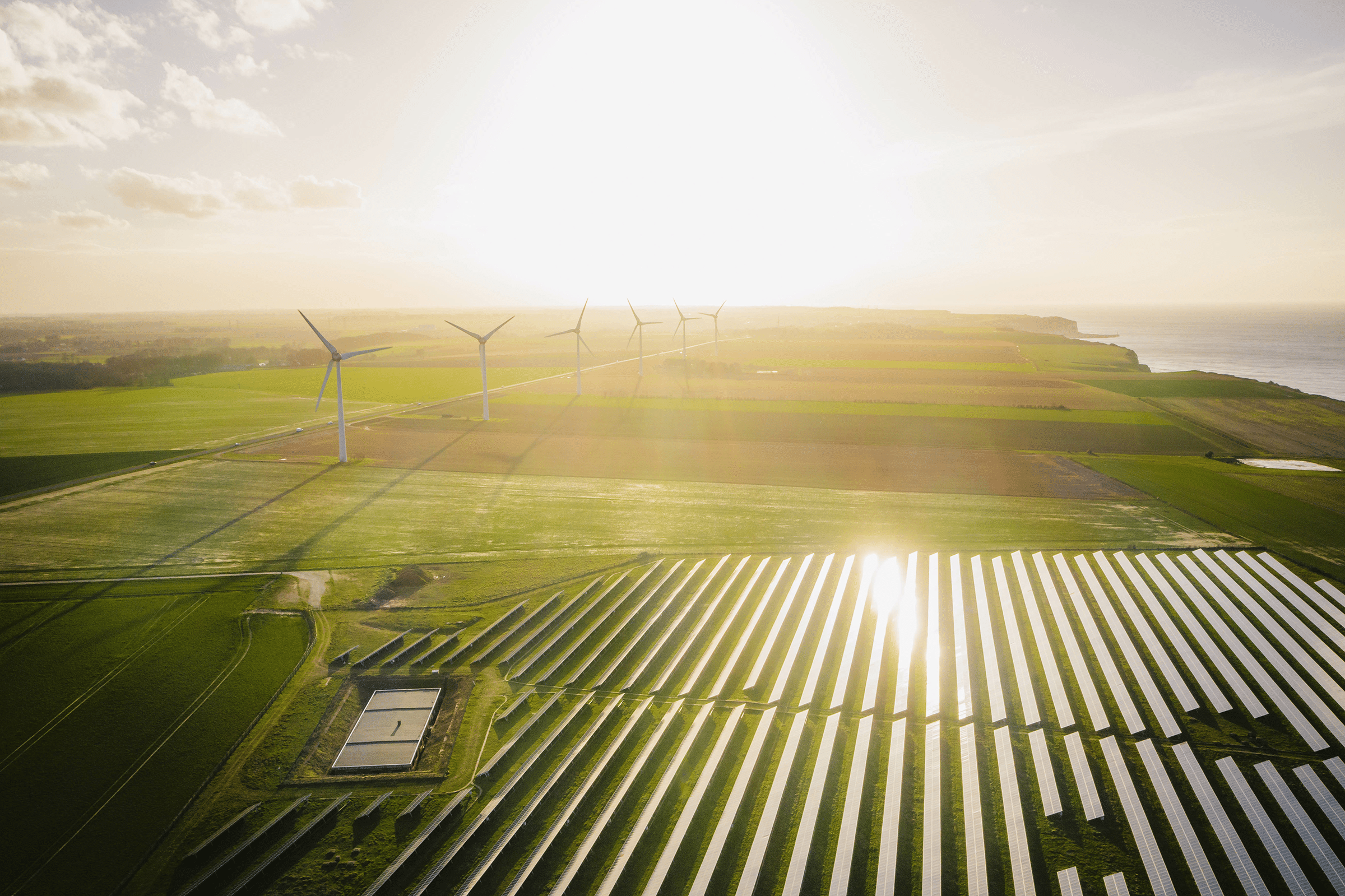 Wind turbines and solar panels farm in a field.