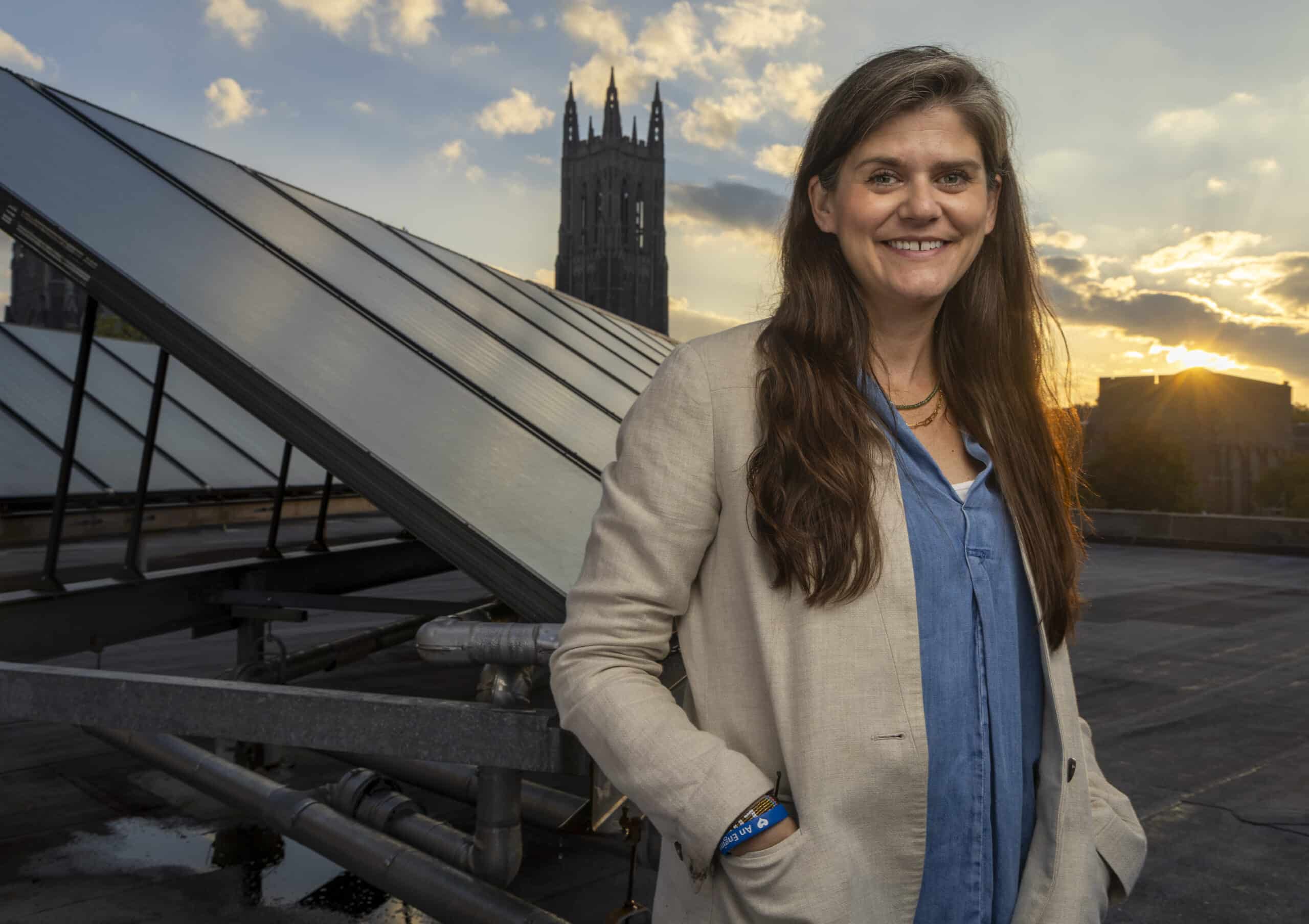 Sara Oliver, director of the Master of Engineering in Climate and Sustainability Engineering, photographed beside solar panels on the Bryan Center rooftop. Oliver is passionate about empowering engineering leaders of the future with the technical knowledge and skills needed to innovate and design solutions to climate challenges within our uncertain and rapidly changing world. Through her career working on large scale infrastructure projects and in partnership with communities who are impacted both by those infrastructure projects and climate change – she has a unique perspective on the increasing demand for engineers equipped to synthesize the big picture of the climate landscape with the technical skills expertise required to implement engineering solutions.