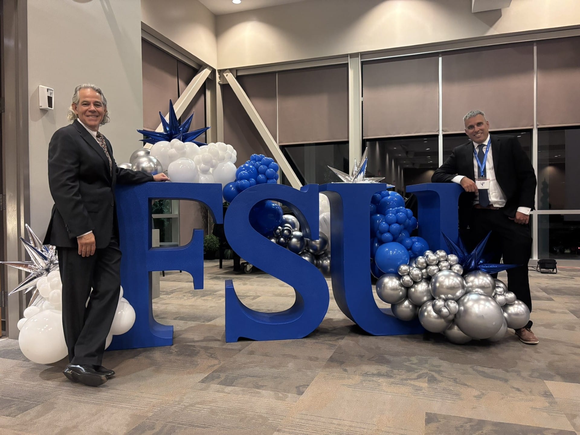 Dr. Lenz and Professor Fimbel in front of a sign that says FSU