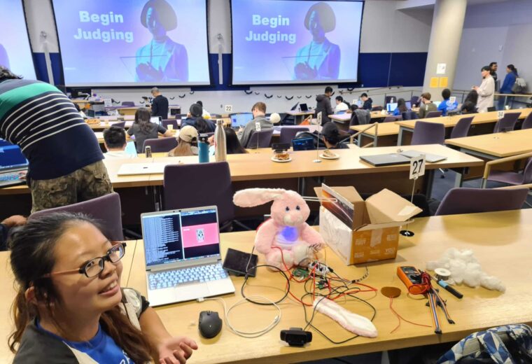 Annabelle Chu, Duke senior in electrical and computer engineering, hacks into her winning entry "BunnyBotBeacon, a robotic plush bunny rabbit that functioned as speaking and listening mental health chatbot.