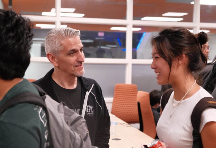 two people discuss in a lecture room